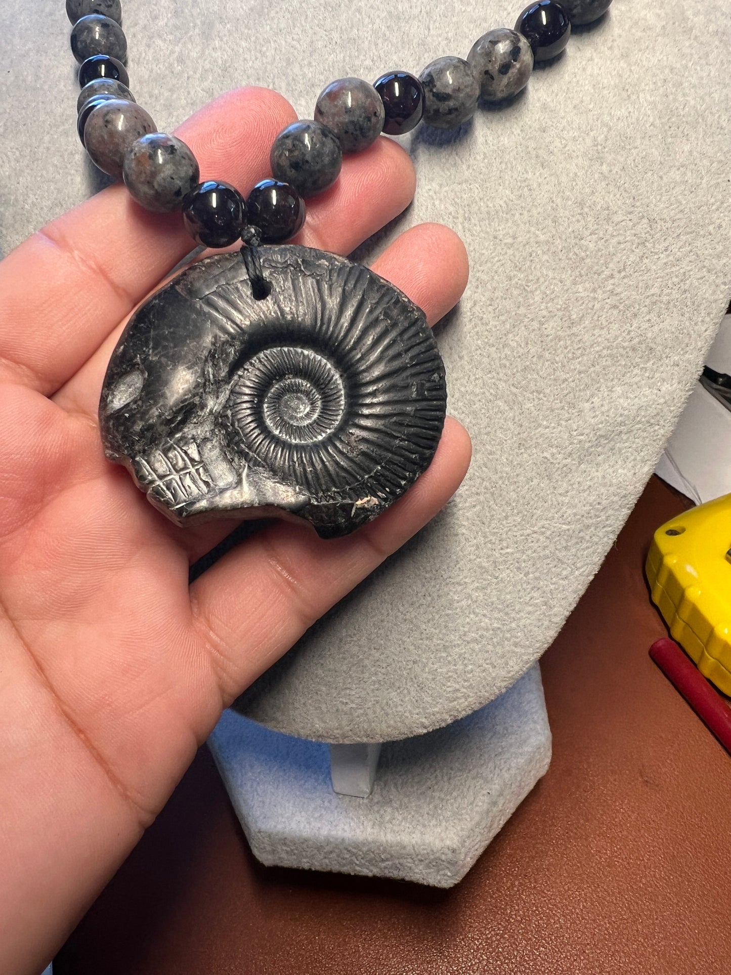 Alien Skull Carved in Ammonite, Necklace translucent garnet spheres yoperlite spheres (#35)