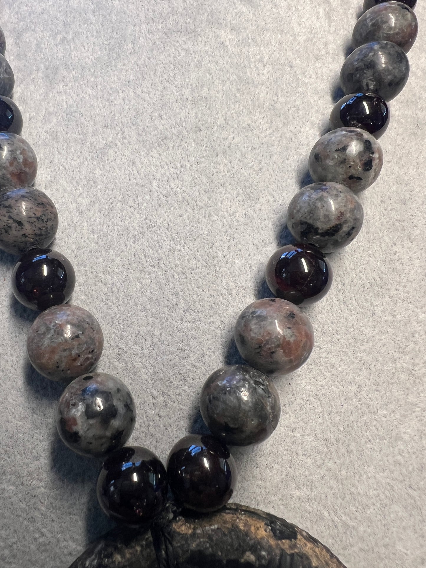 Alien Skull Carved in Ammonite, Necklace translucent garnet spheres yoperlite spheres (#35)