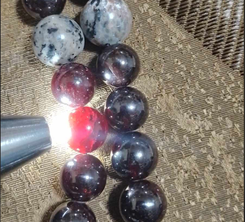 Alien Skull Carved in Ammonite, Necklace translucent garnet spheres yoperlite spheres (#35)