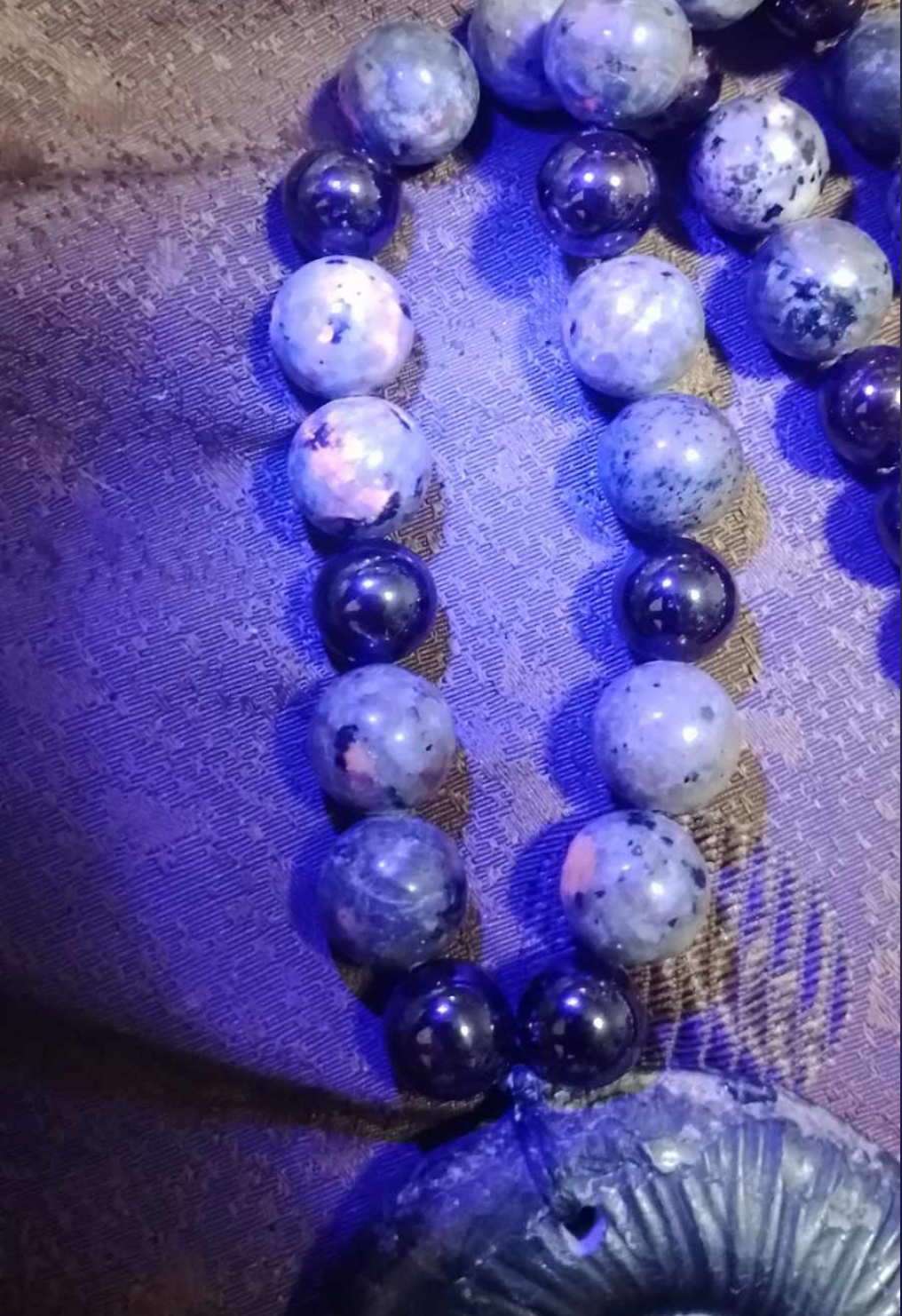Alien Skull Carved in Ammonite, Necklace translucent garnet spheres yoperlite spheres (#35)